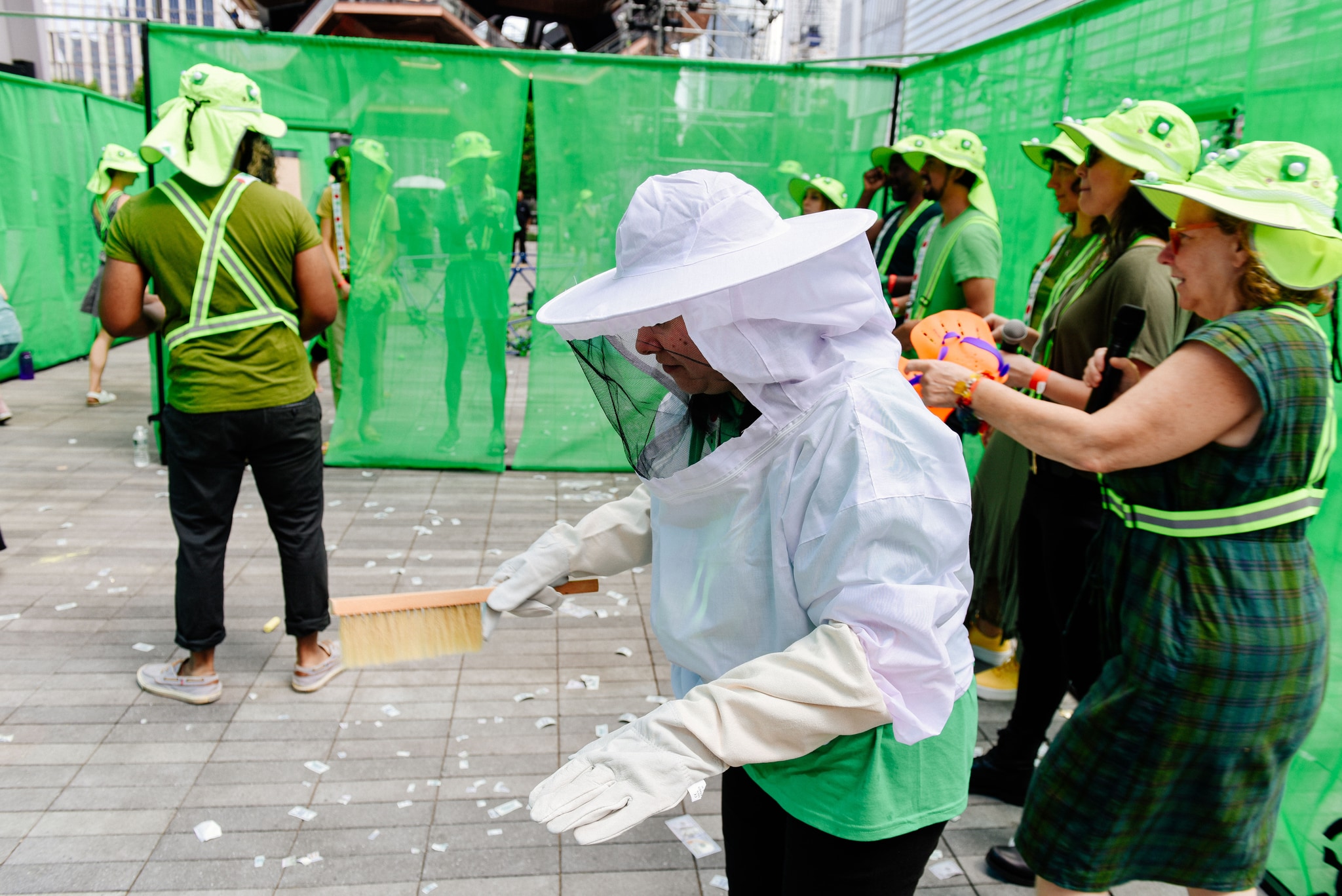 A group of participants in green hats outside The Shed.