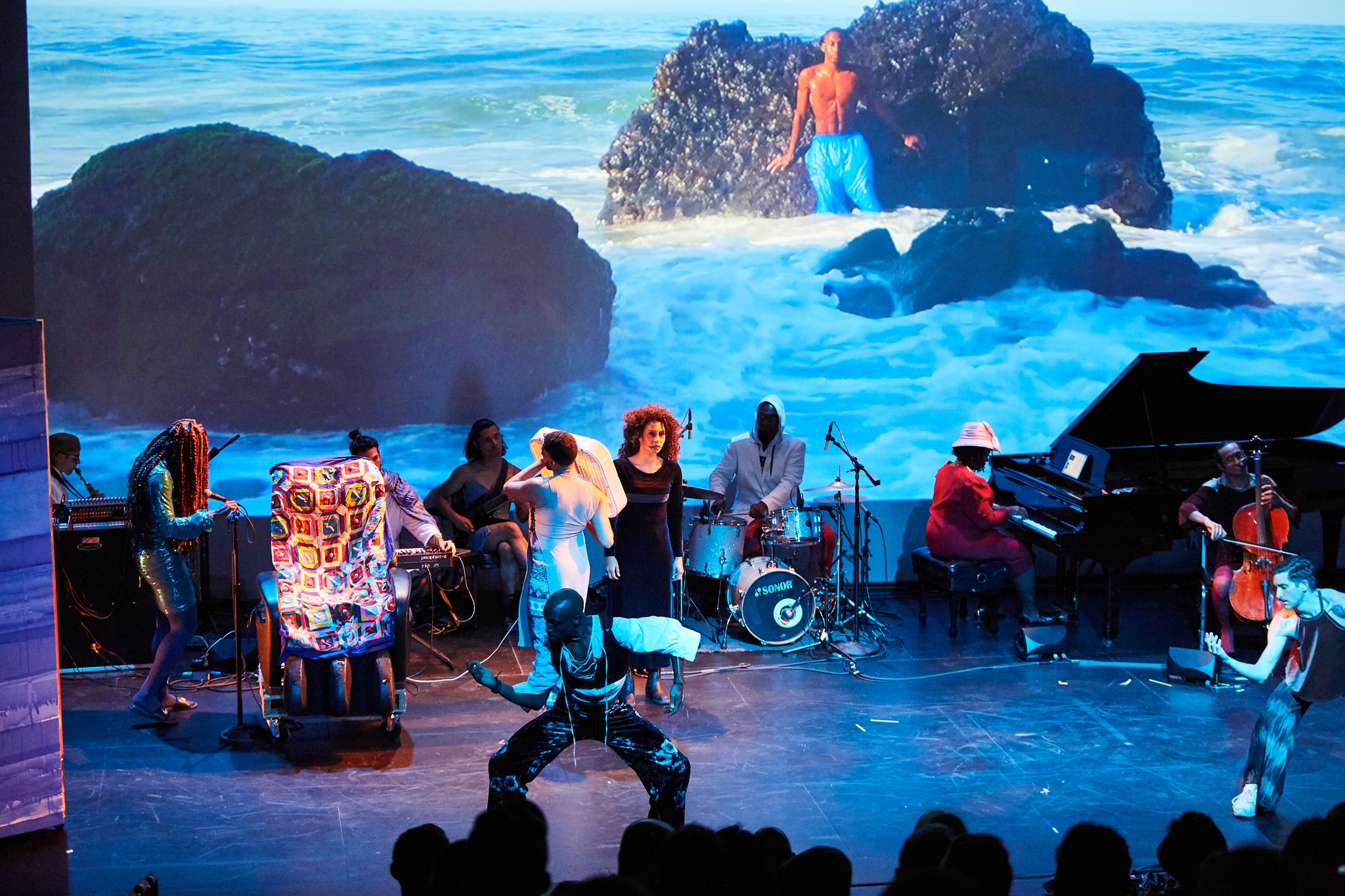 Dancers and musicians performing together on a stage.