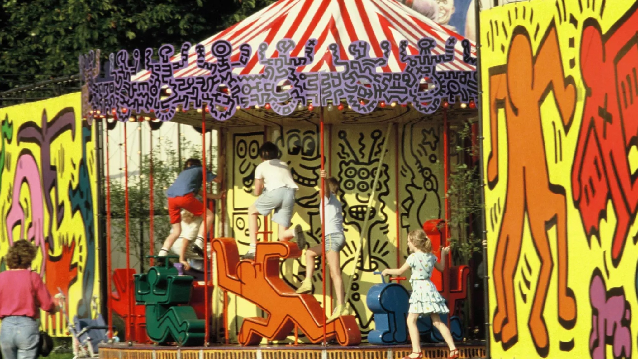 Children play on a carousel designed by artist Keith Haring at the original Luna Luna in Hamburg, Germany, in 1987. 