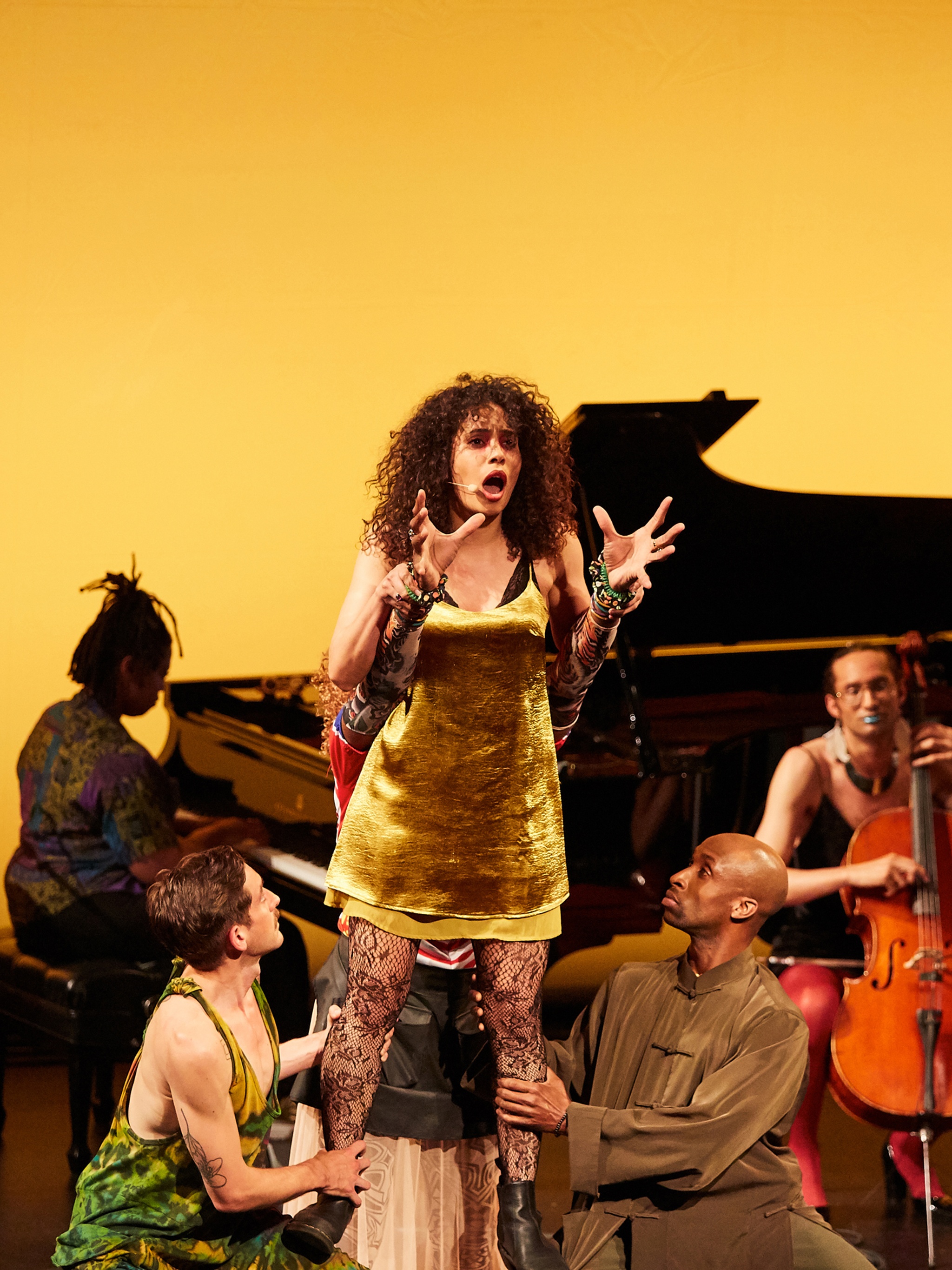 Woman singing on stage with other performers in Richard Kennedy's *HIR*