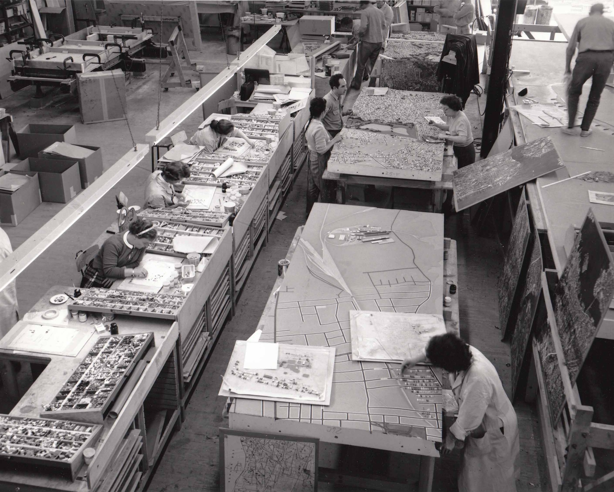 A workshop with workers at drafting boards constructing panels of The Panorama of the City of New York