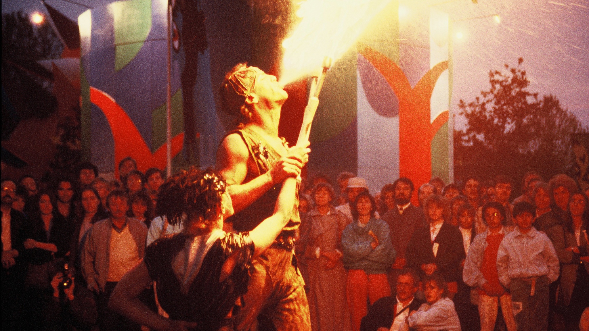 A performer at the original Luna Luna in Hamburg Germany in 1987 breathes a burst of fire. 