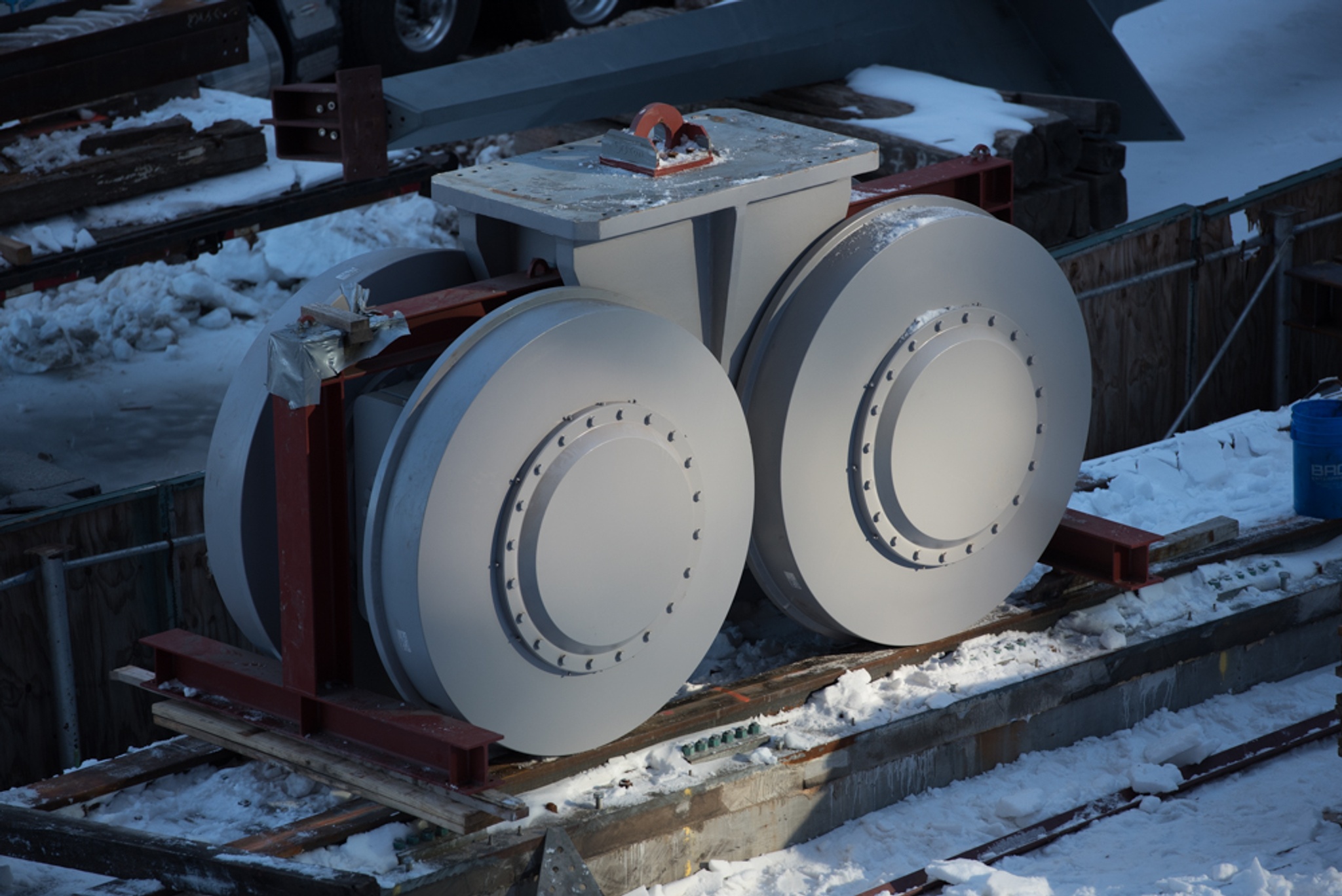 The Shed's bogie wheels pictured with snow on the ground. These wheels carry The Shed's moveable shell as it deploys over the Plaza and nests back over the fixed building. 