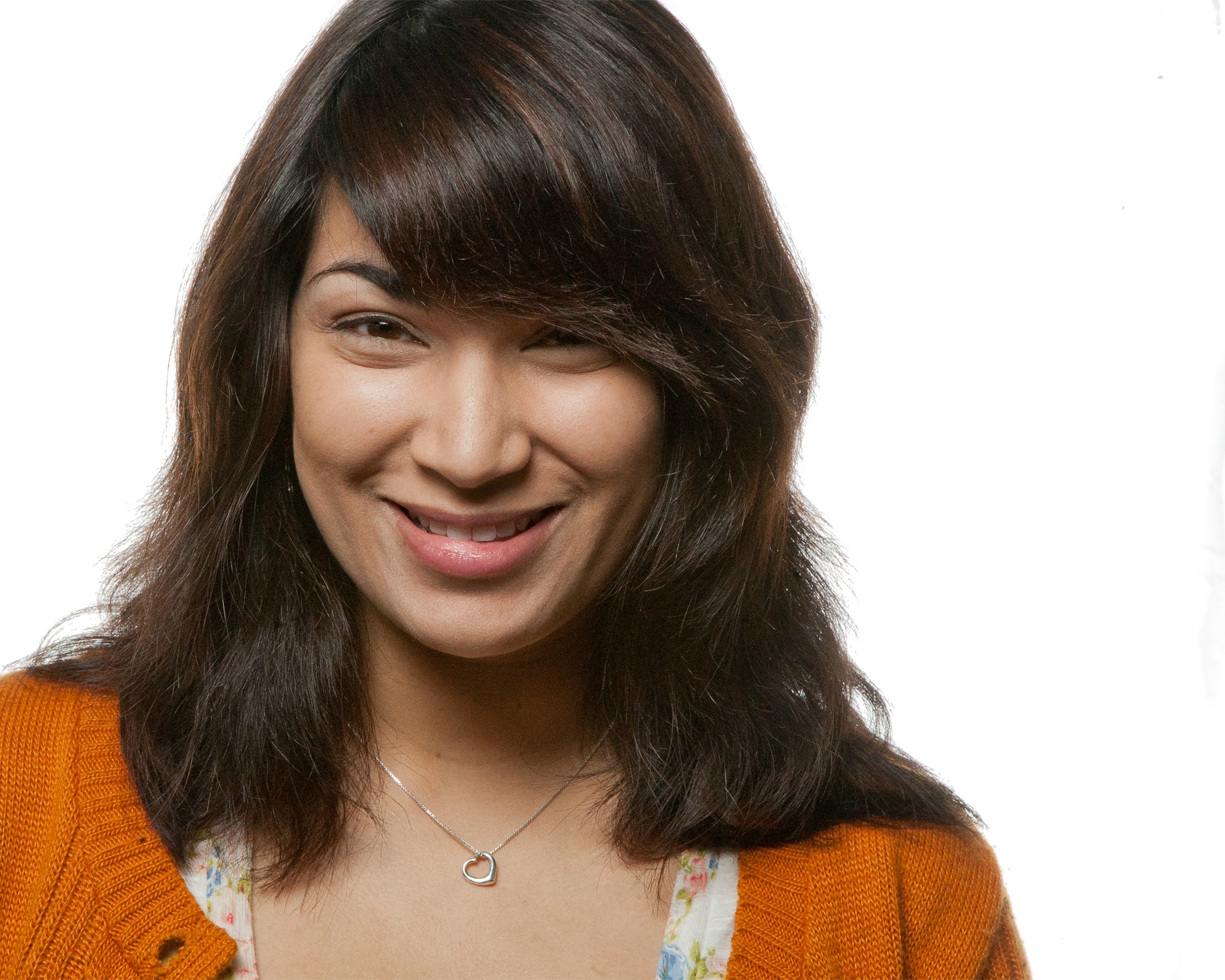 Composer and sound designer Elisheba Ittoop smiling with her bangs falling over her brow