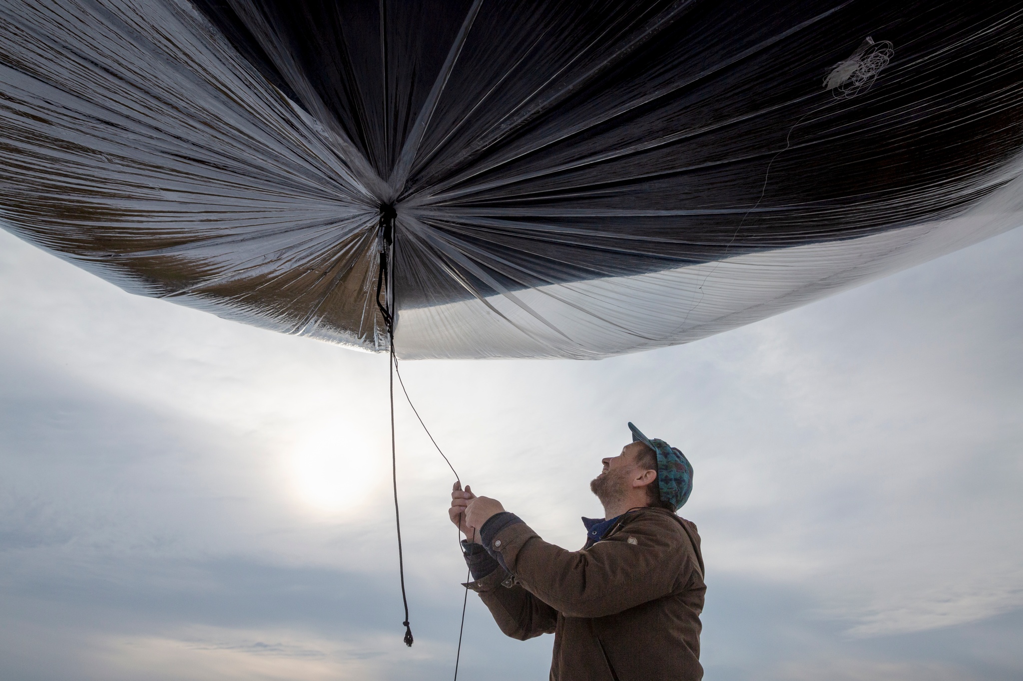 Tomas holding large balloon.