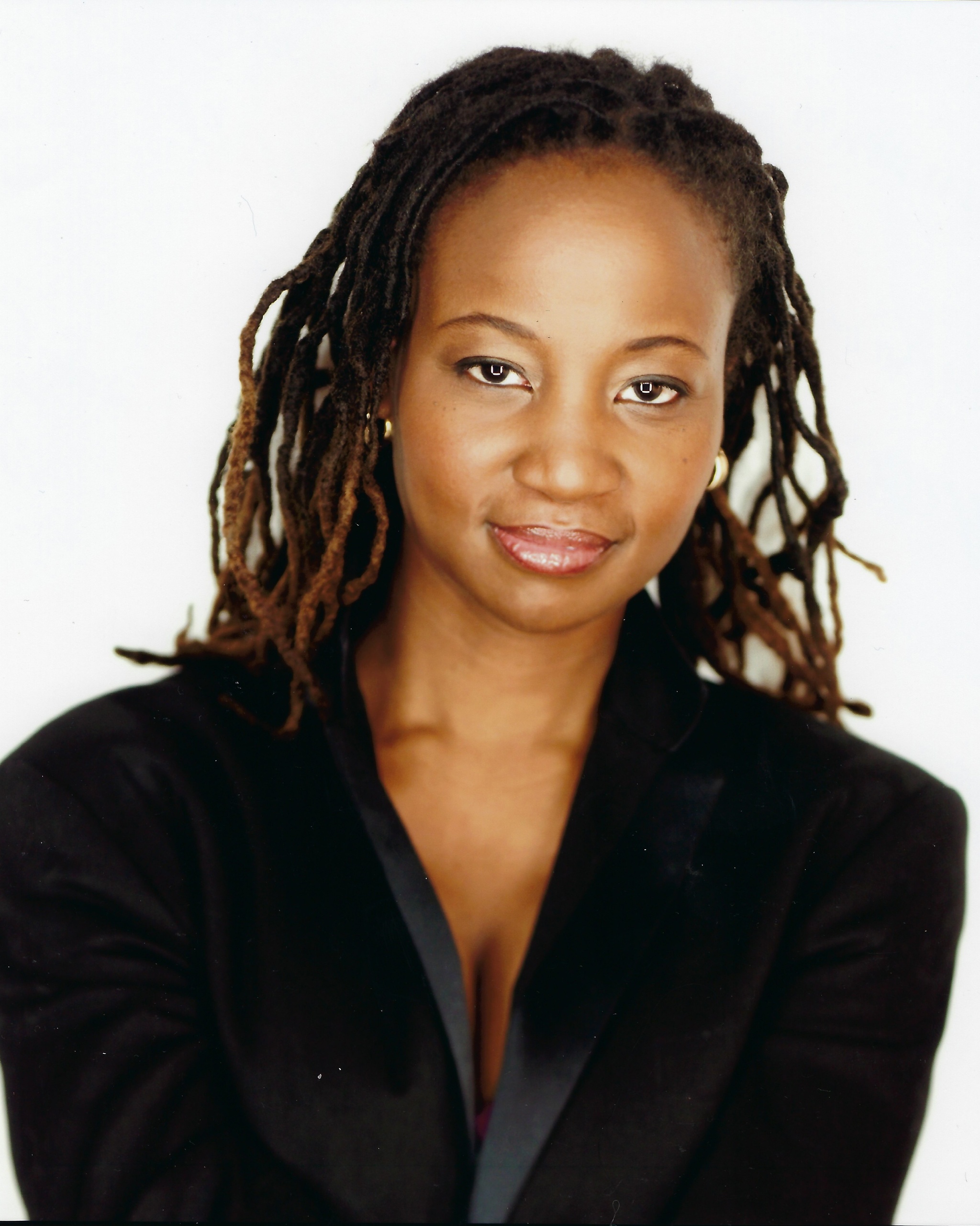 A portrait of Melanie Nicholls-King wearing a black blazer