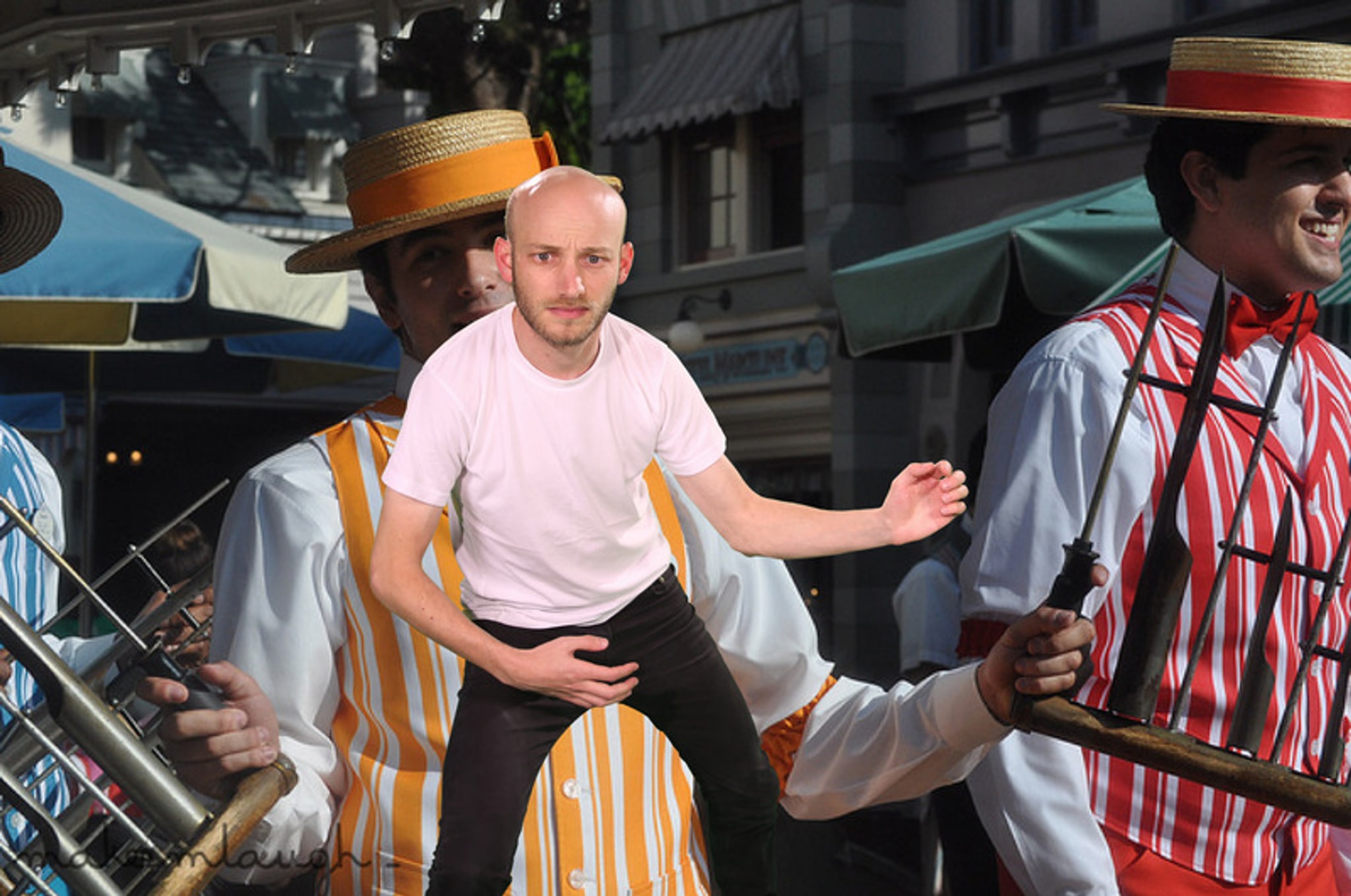 A photo from Sam Lavigne's Open Call commission Training Poses depicting Two uniformed workers performing tricks at a carnival