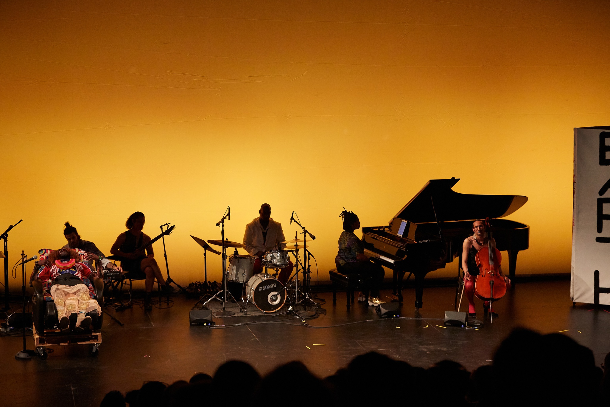 Dancers and musicians performing together on a stage.